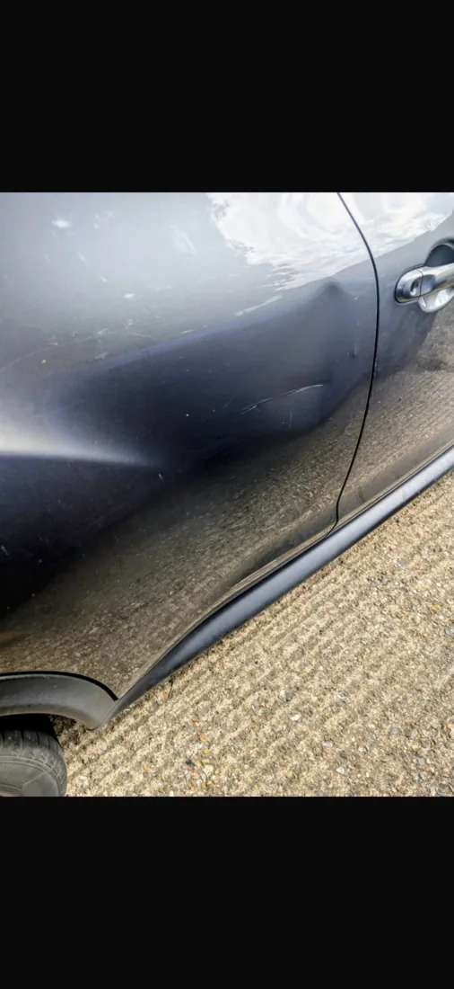 Nissan — door dent repair: before